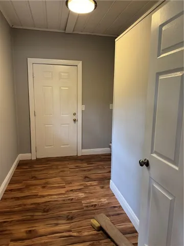 a view of room with wooden floor