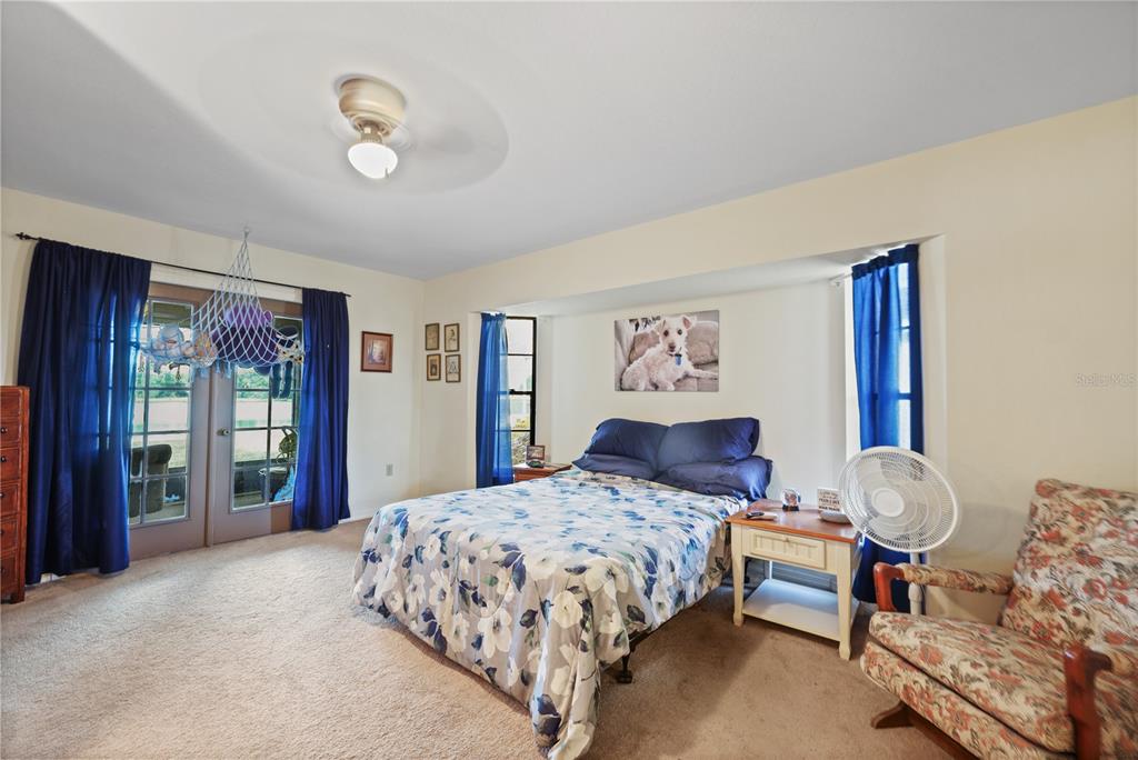 25192 Derringer Road Punta Gorda, FL 33983 - Photo 23 of 39 a bedroom with a large bed and a large window