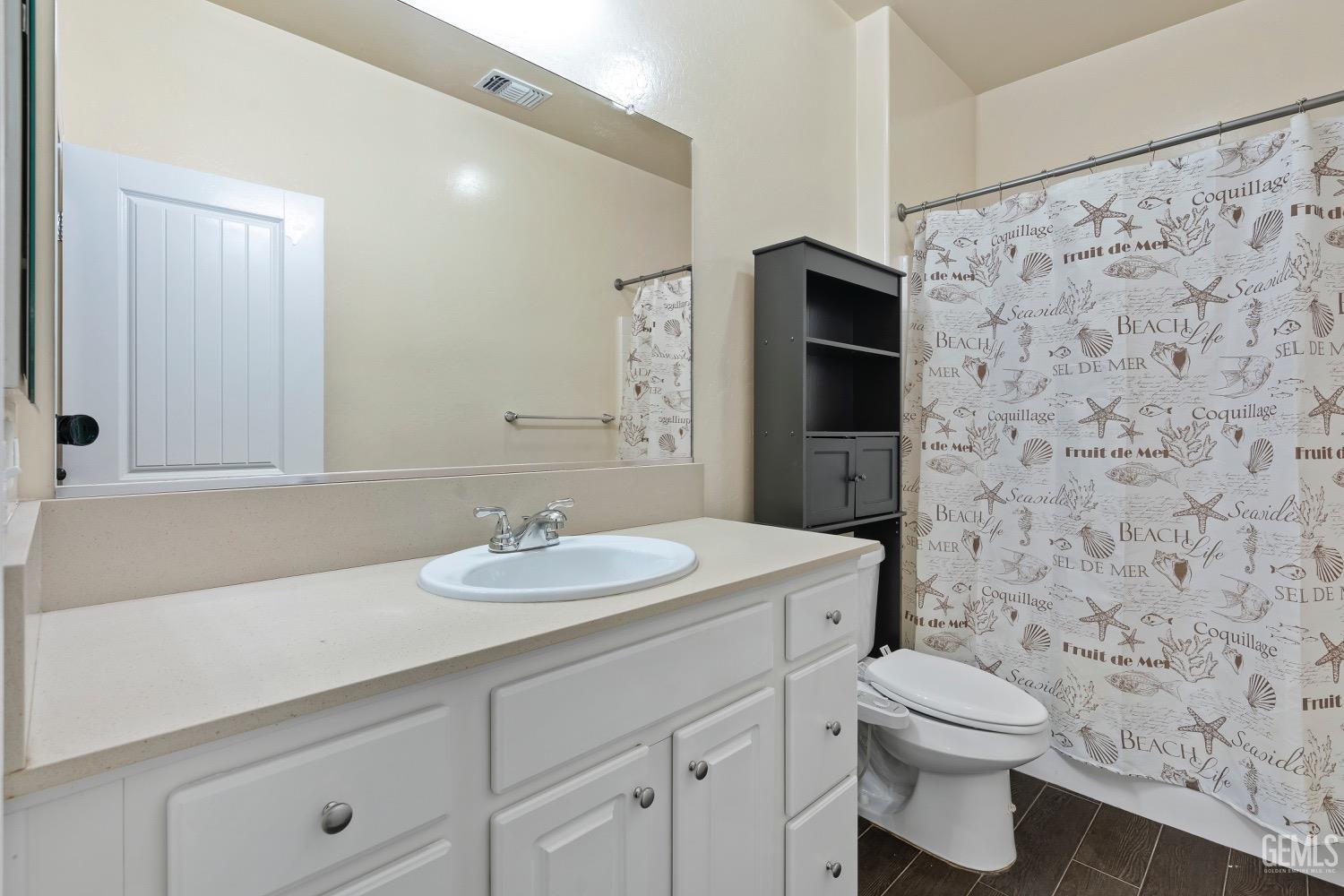 Undisclosed Address Bakersfield, CA 93311 - Photo 13 of 27 a bathroom with a toilet sink and mirror