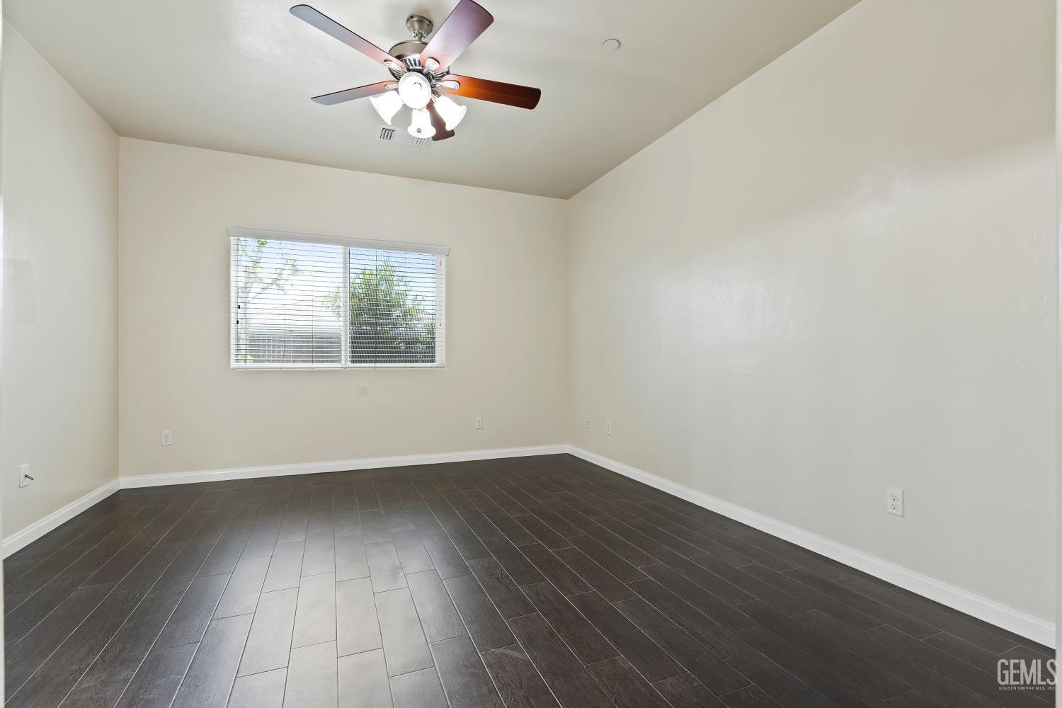 Undisclosed Address Bakersfield, CA 93311 - Photo 17 of 27 a view of an empty room with wooden floor and a window