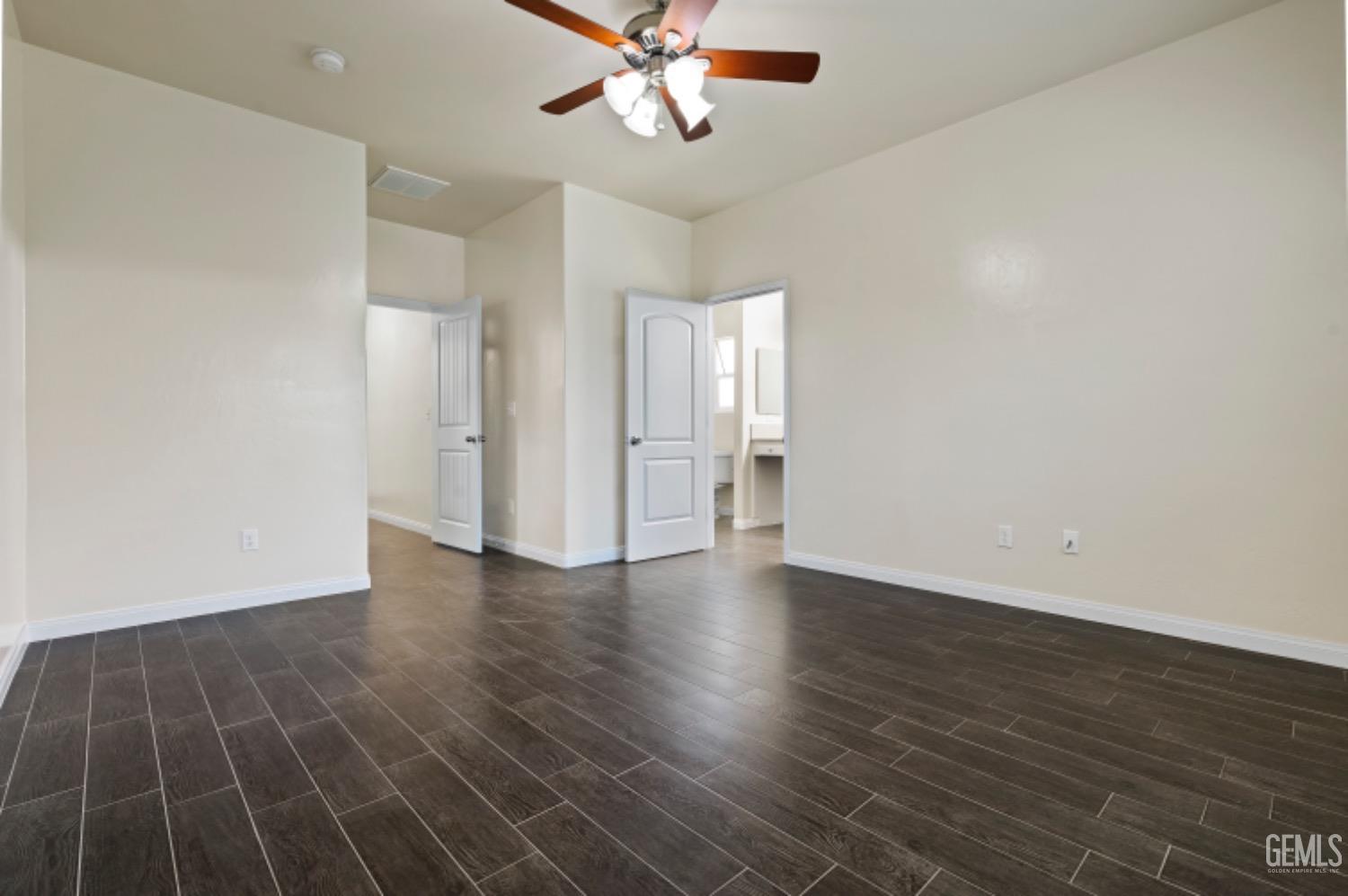 Undisclosed Address Bakersfield, CA 93311 - Photo 18 of 27 an empty room with wooden floor ceiling fan and windows
