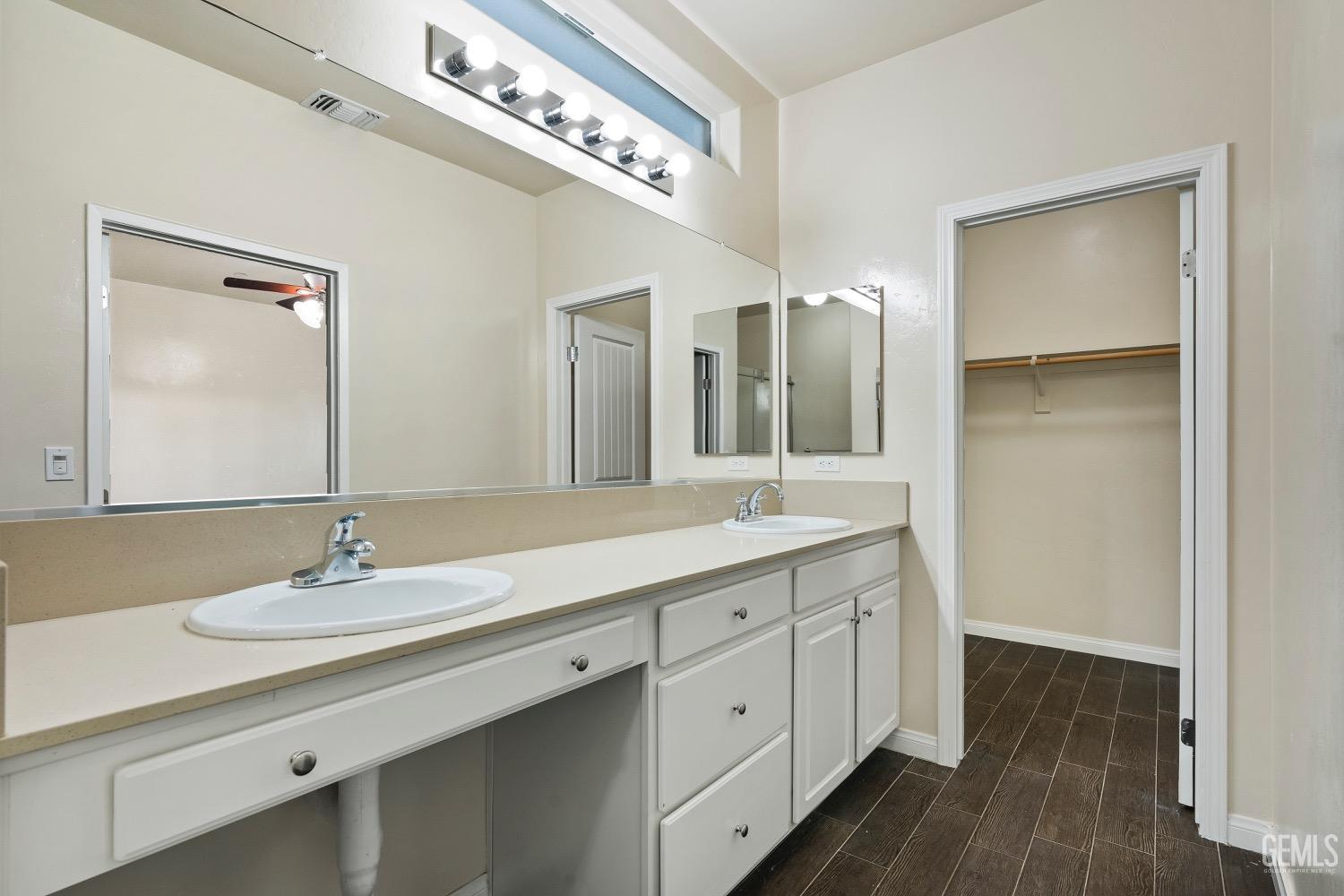 Undisclosed Address Bakersfield, CA 93311 - Photo 20 of 27 a bathroom with a double vanity sink and a mirror