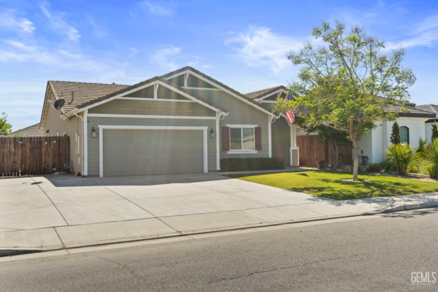 Undisclosed Address Bakersfield, CA 93311 - Photo 2 of 27 a front view of a house with a yard and garage