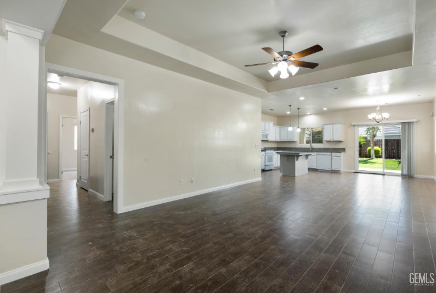Undisclosed Address Bakersfield, CA 93311 - Photo 6 of 27 wooden floor in an empty room with a kitchen