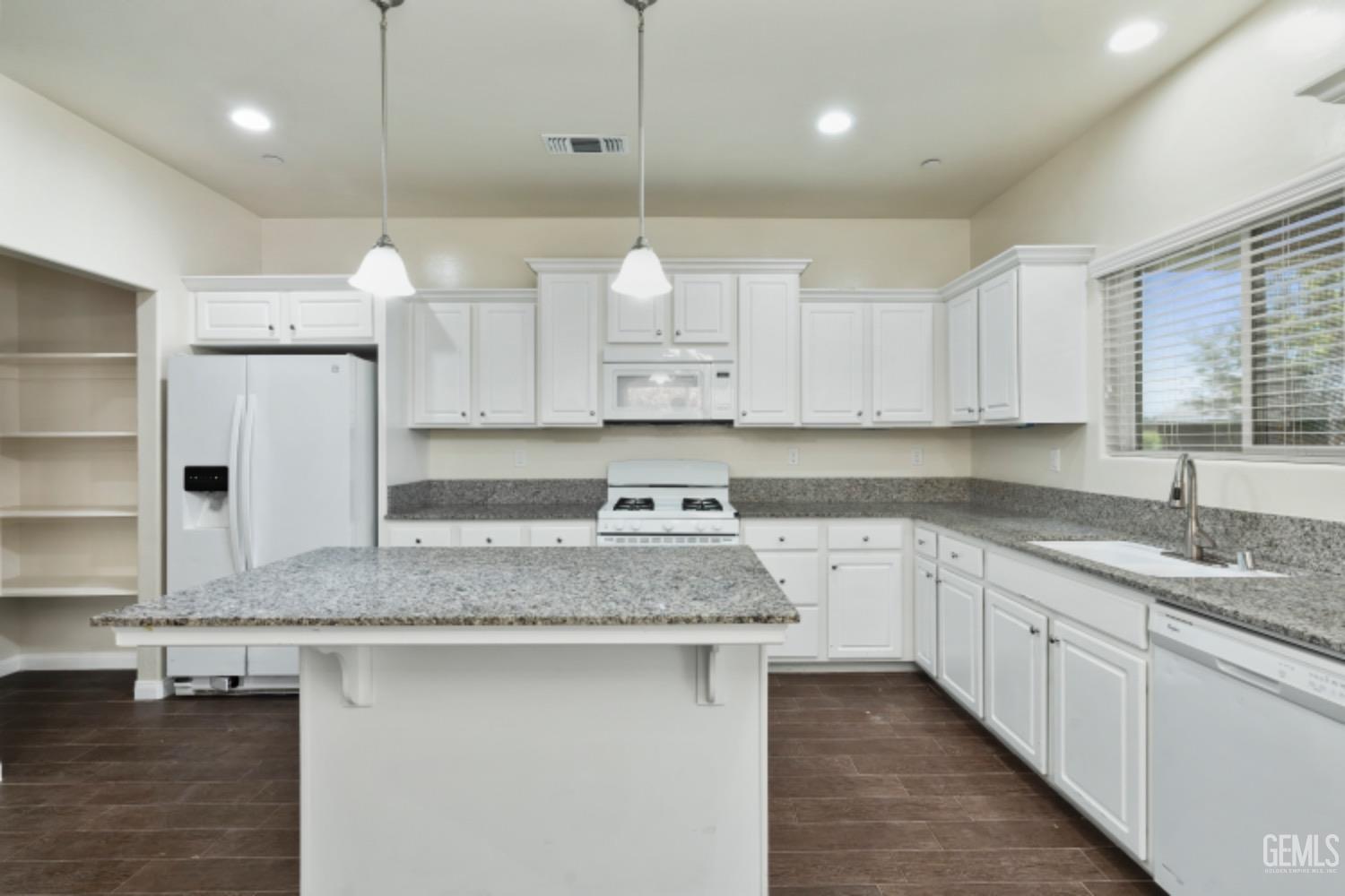 Undisclosed Address Bakersfield, CA 93311 - Photo 10 of 27 a kitchen with a sink stove and cabinets