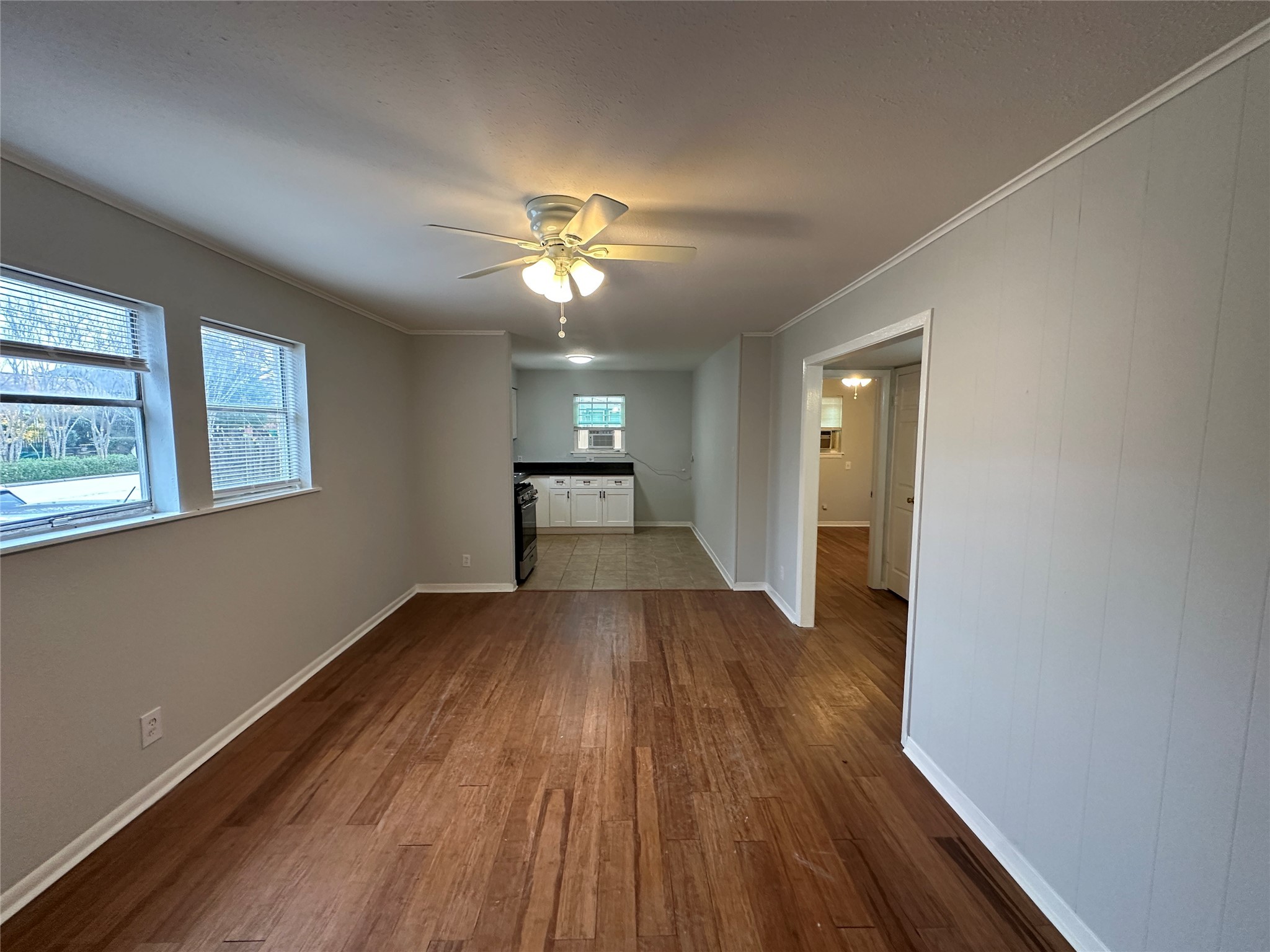 4911 Delano Street, Unit 1 Houston, TX 77004 - Photo 2 of 9 a view of empty room with wooden floor and fan