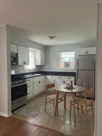 a kitchen with a table and chairs in it