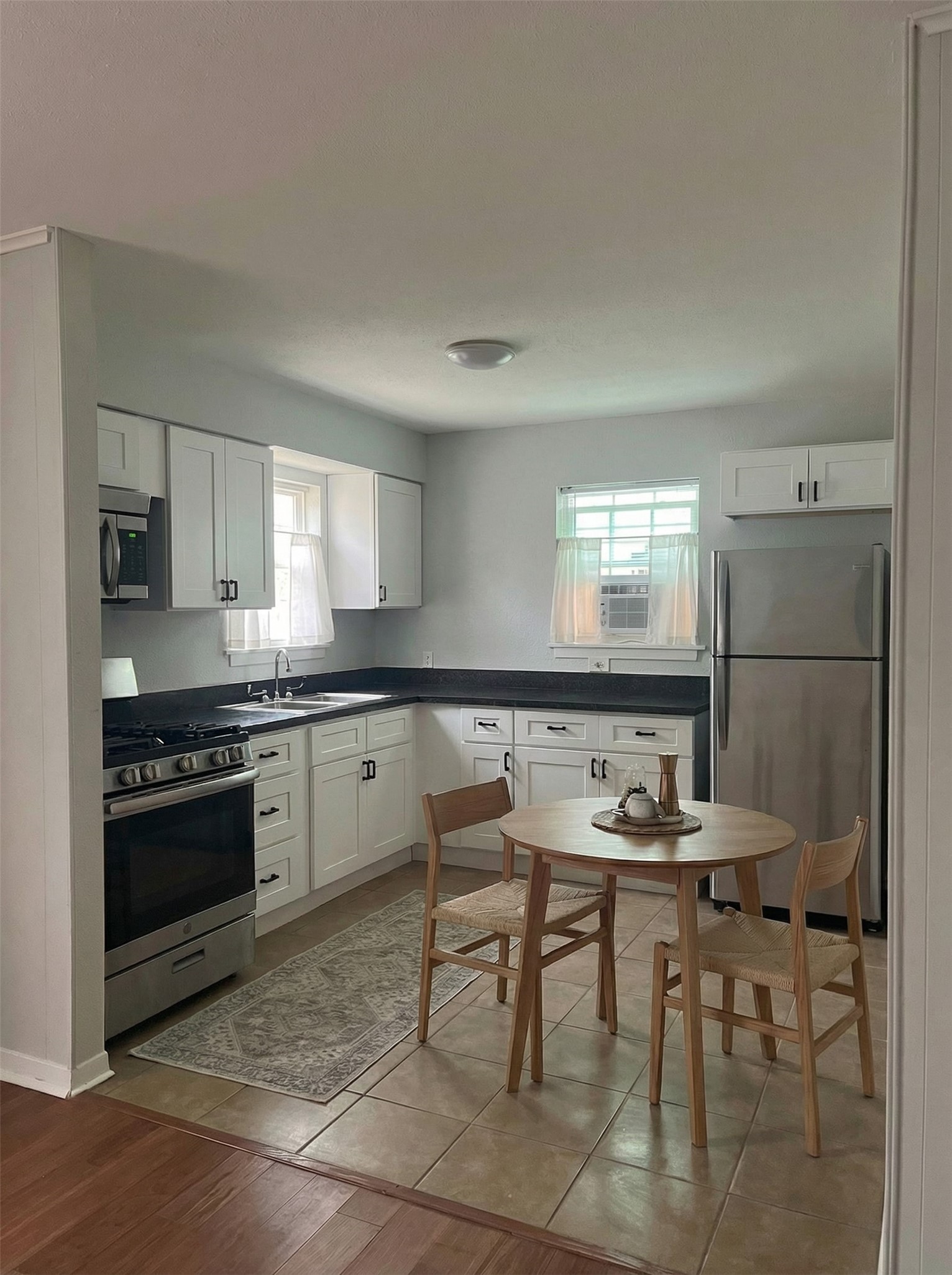 4911 Delano Street, Unit 1 Houston, TX 77004 - Photo 2 of 14 a kitchen with a table and chairs in it