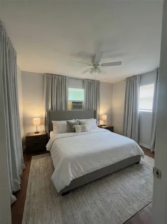 a bedroom with a bed and a mirror