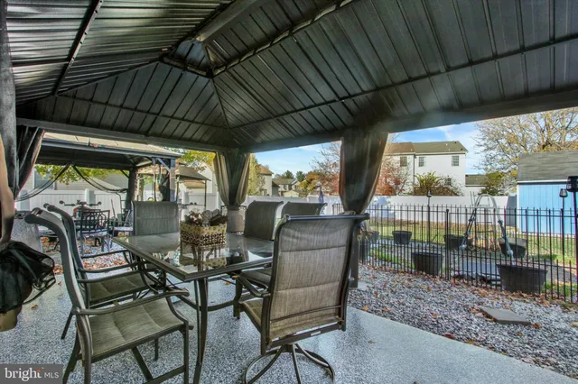 a view of swimming pool with a garden and patio