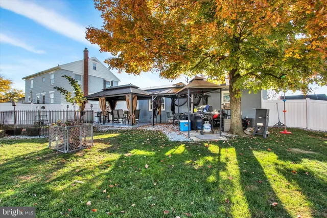 a front view of a house with a yard table and chairs