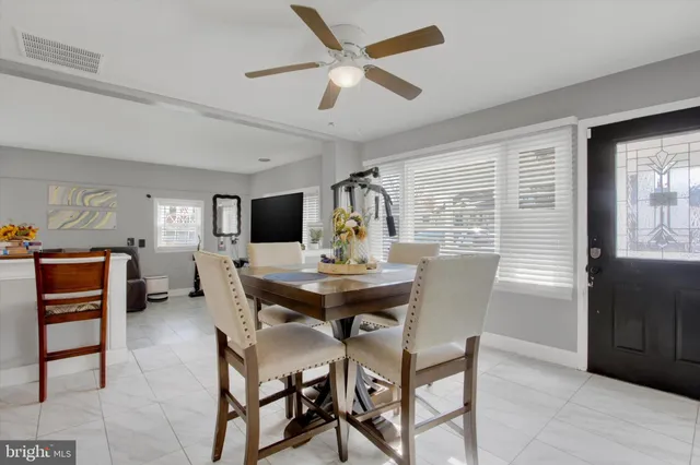 a view of a dining room and livingroom with furniture window and wooden floor