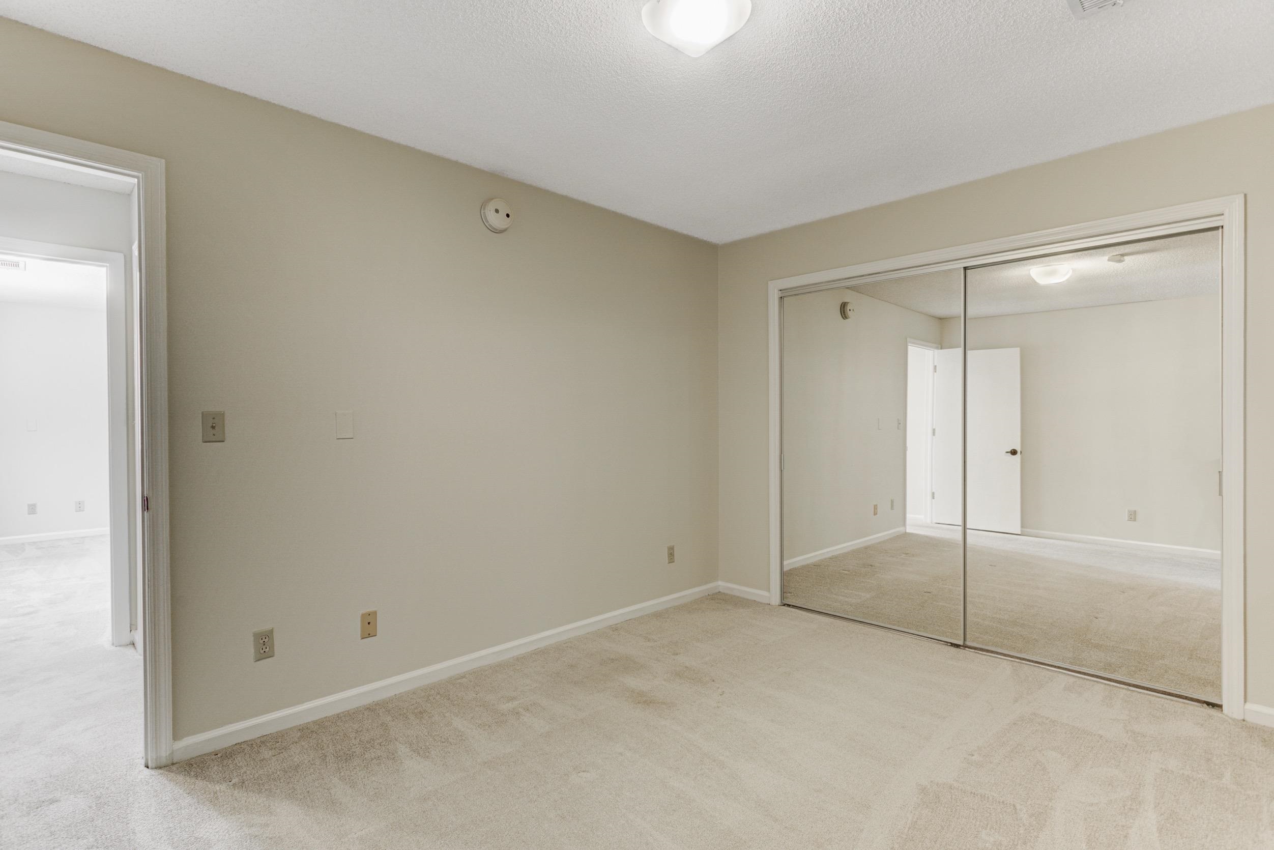 5013 Scheibler Road, Unit C1 Memphis, TN 38128 - Photo 16 of 36 Unfurnished bedroom with light carpet, a closet, and a textured ceiling