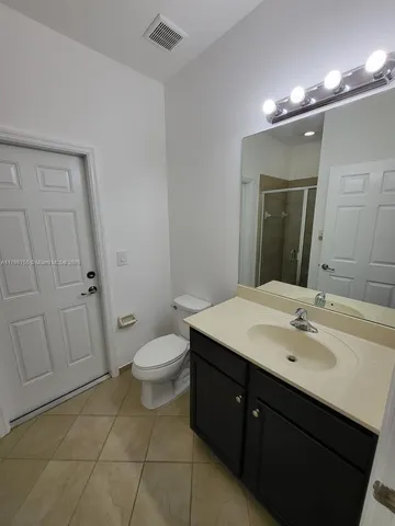 a spacious bathroom with a toilet sink and mirror