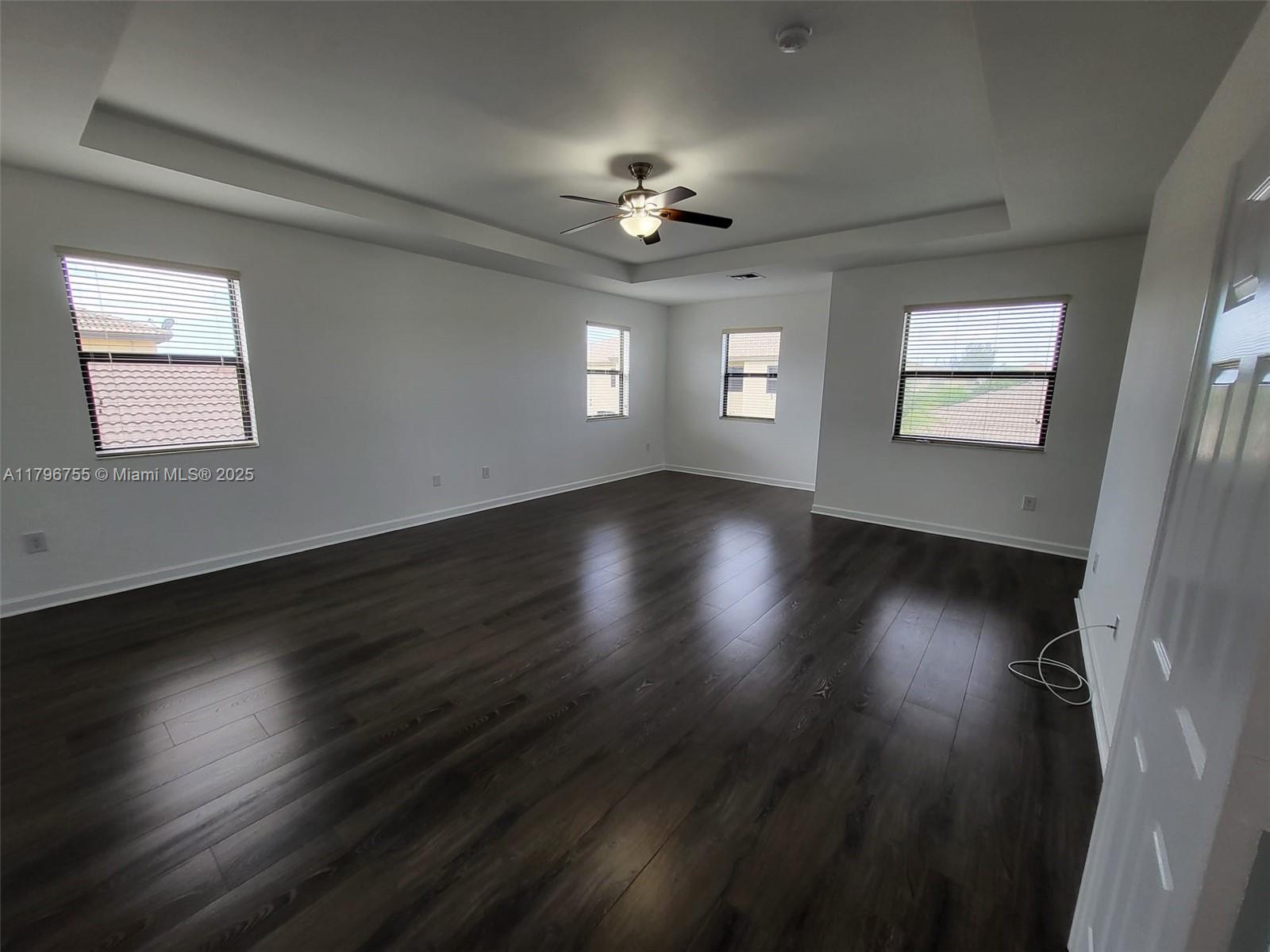 11729 Southwest 236th Street Homestead, FL 33032 - Photo 16 of 22 wooden floor in an empty room with a window