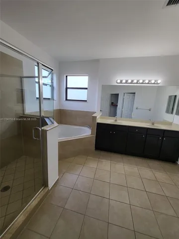 a large bathroom with a large tub and sink