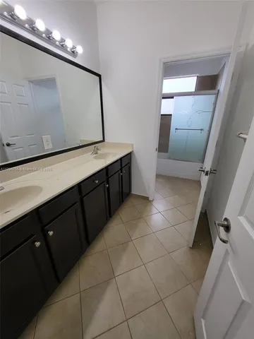a bathroom with a sink mirror and toilet