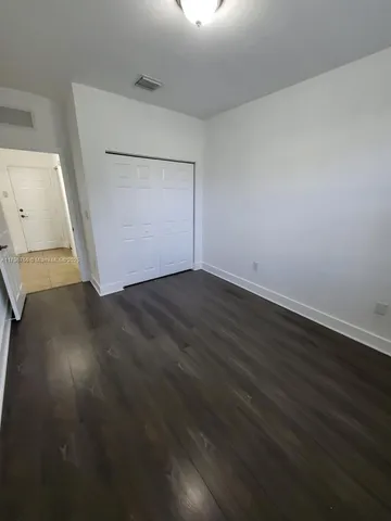 an empty room with wooden floor