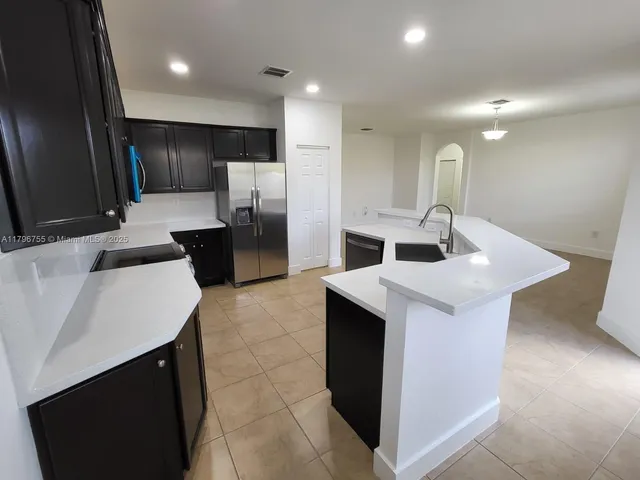 a kitchen with a sink and refrigerator