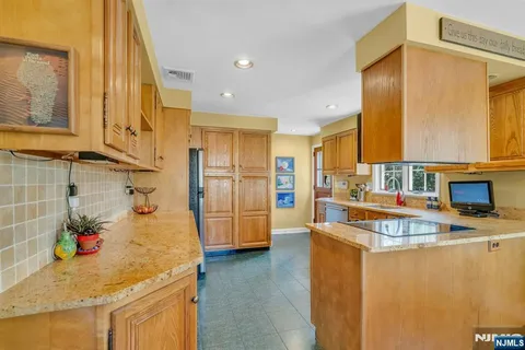 a kitchen with stainless steel appliances granite countertop a stove and a refrigerator