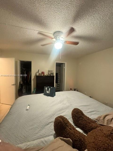 6900 Southwest 39th Street, Unit 106J Davie, FL 33314 - Photo 6 of 9 a bedroom with a bed and a chandelier