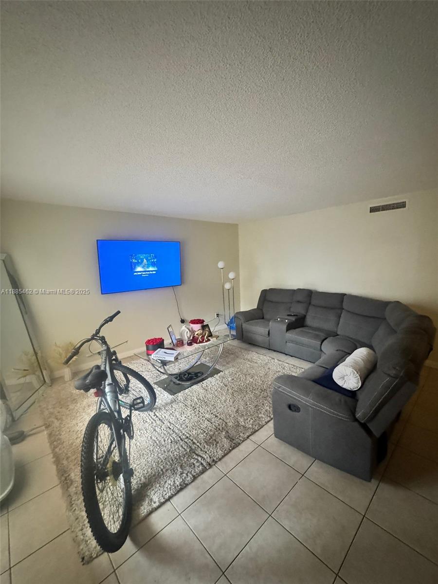 6900 Southwest 39th Street, Unit 106J Davie, FL 33314 - Photo 9 of 9 a living room with furniture and a couch