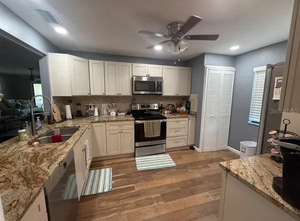 a kitchen with granite countertop a stove and a sink