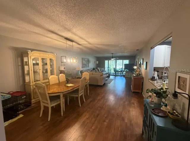 a living room with furniture a wooden floor and a sink