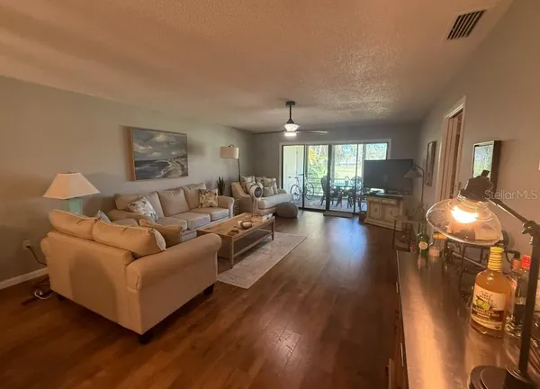 a living room with furniture and a wooden floor