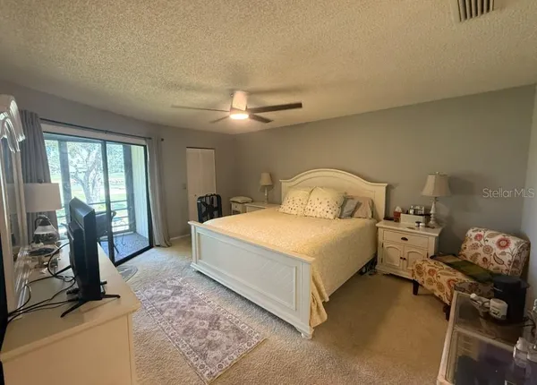 a bedroom with a bed and a tv