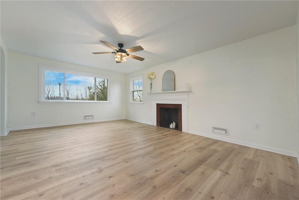 657 Ridge Road Pittsburgh, PA 15205 - Photo 12 of 30 a view of empty room with fireplace and a ceiling fan