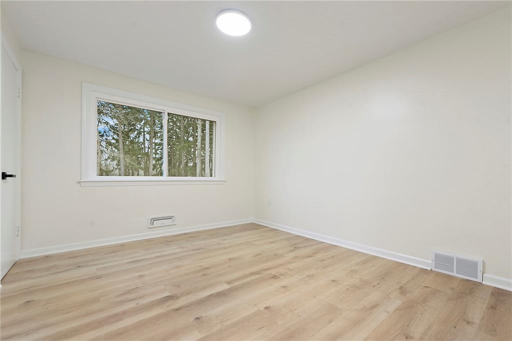 657 Ridge Road Pittsburgh, PA 15205 - Photo 23 of 30 an empty room with wooden floor and windows