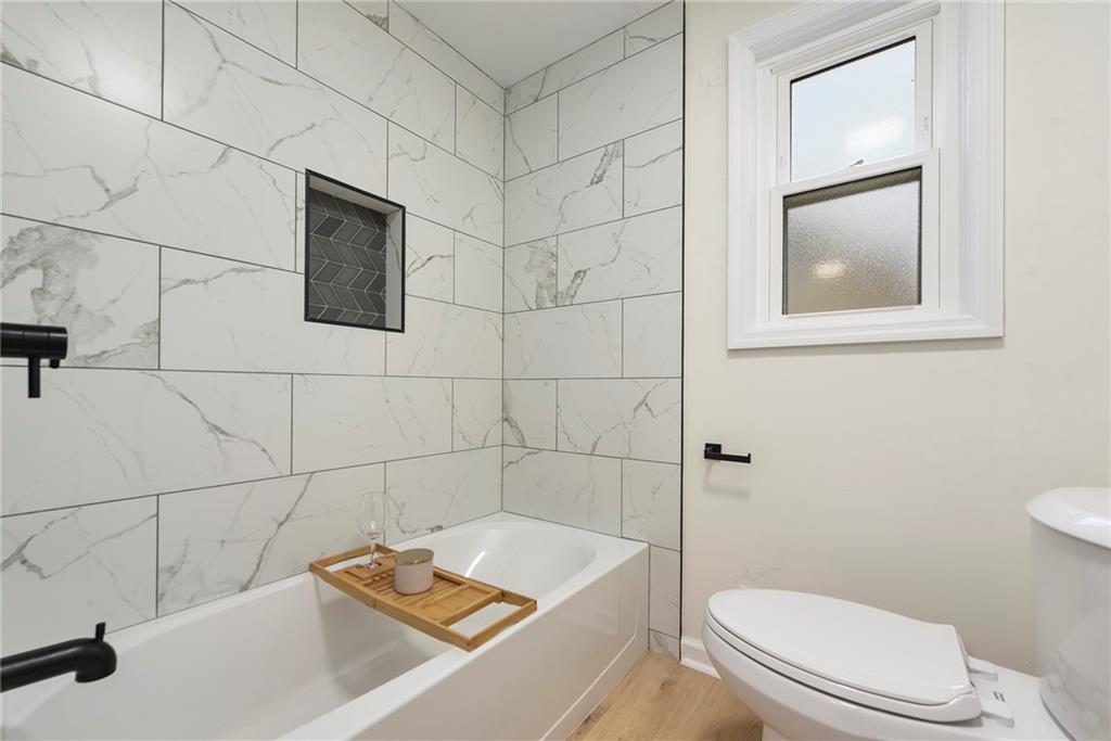 657 Ridge Road Pittsburgh, PA 15205 - Photo 9 of 30 a bathroom with a sink a toilet and a mirror