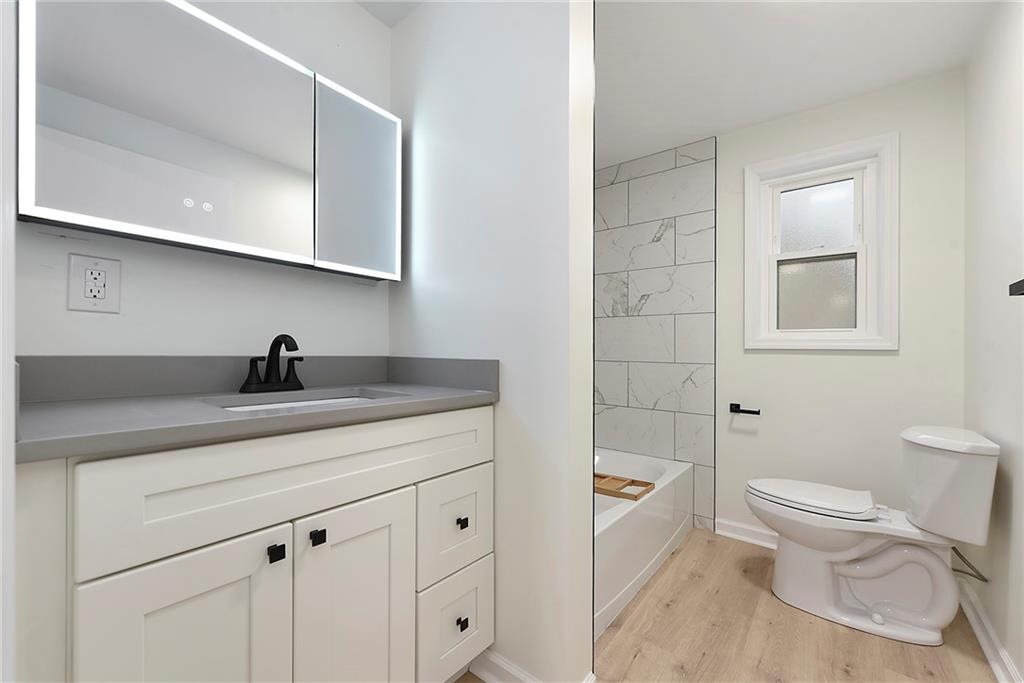 657 Ridge Road Pittsburgh, PA 15205 - Photo 10 of 30 a spacious bathroom with a toilet a sink and mirror