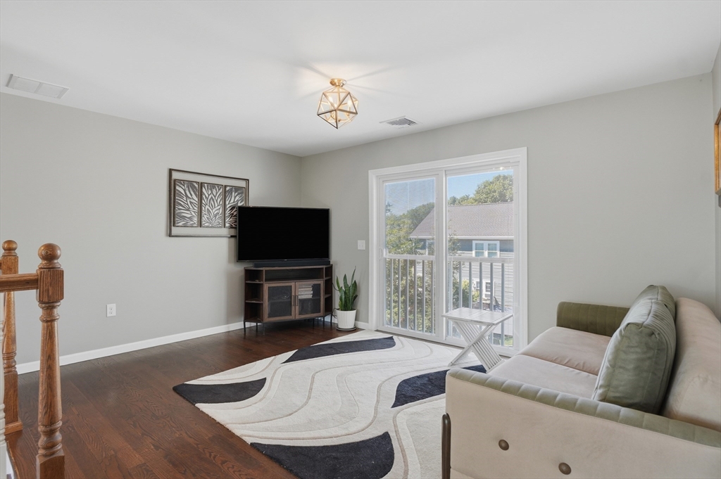112 Pineland Avenue Worcester, MA 01604 - Photo 19 of 38 a living room with furniture and a flat screen tv