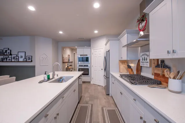a kitchen with a sink stove and refrigerator