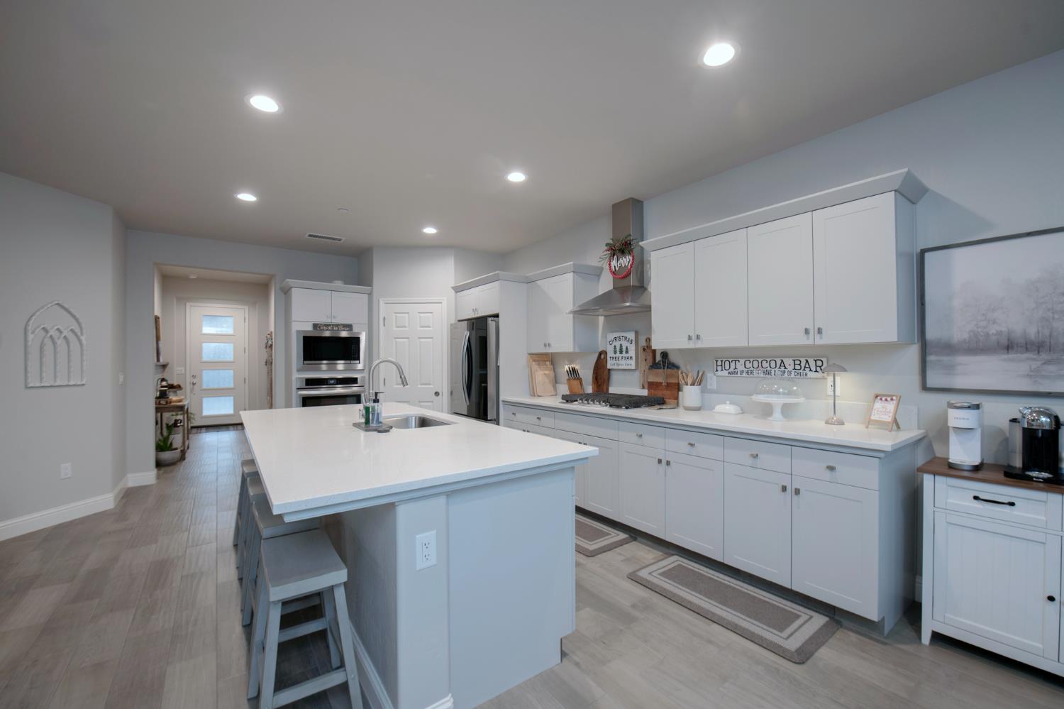 2121 Descanso Avenue Clovis, CA 93619 - Photo 14 of 37 a large white kitchen with kitchen island a sink appliances and cabinets