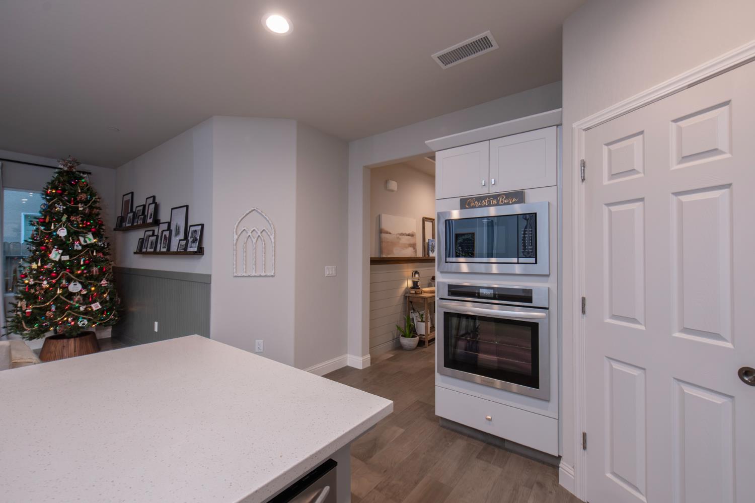 2121 Descanso Avenue Clovis, CA 93619 - Photo 16 of 37 a kitchen with a stove a microwave and a refrigerator