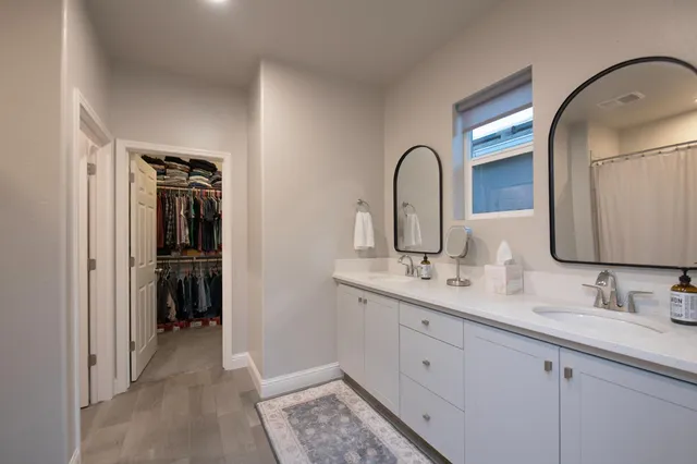 a bathroom with a double vanity sink and a mirror