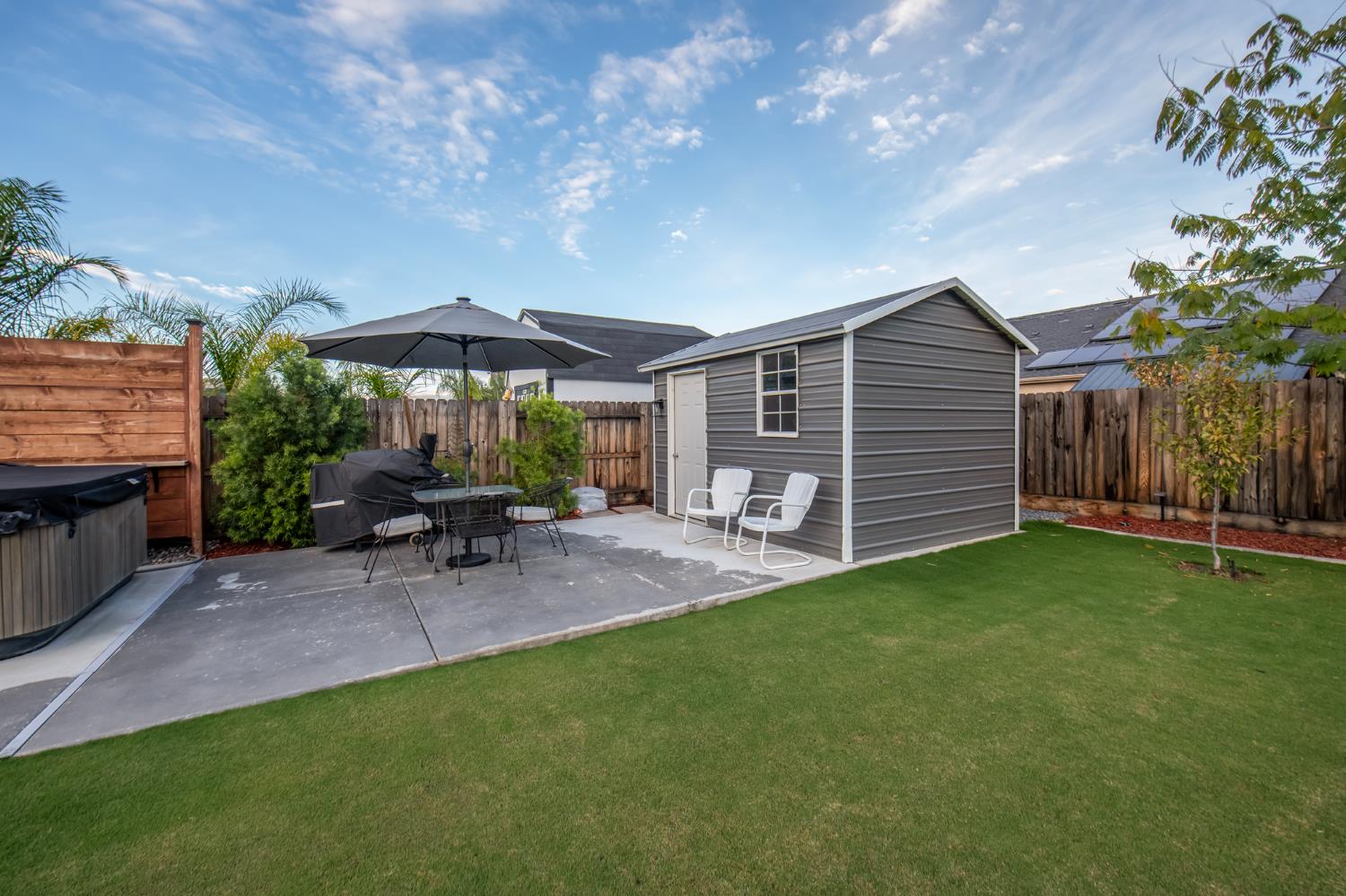 2121 Descanso Avenue Clovis, CA 93619 - Photo 30 of 37 a view of a patio with table and chairs under an umbrella