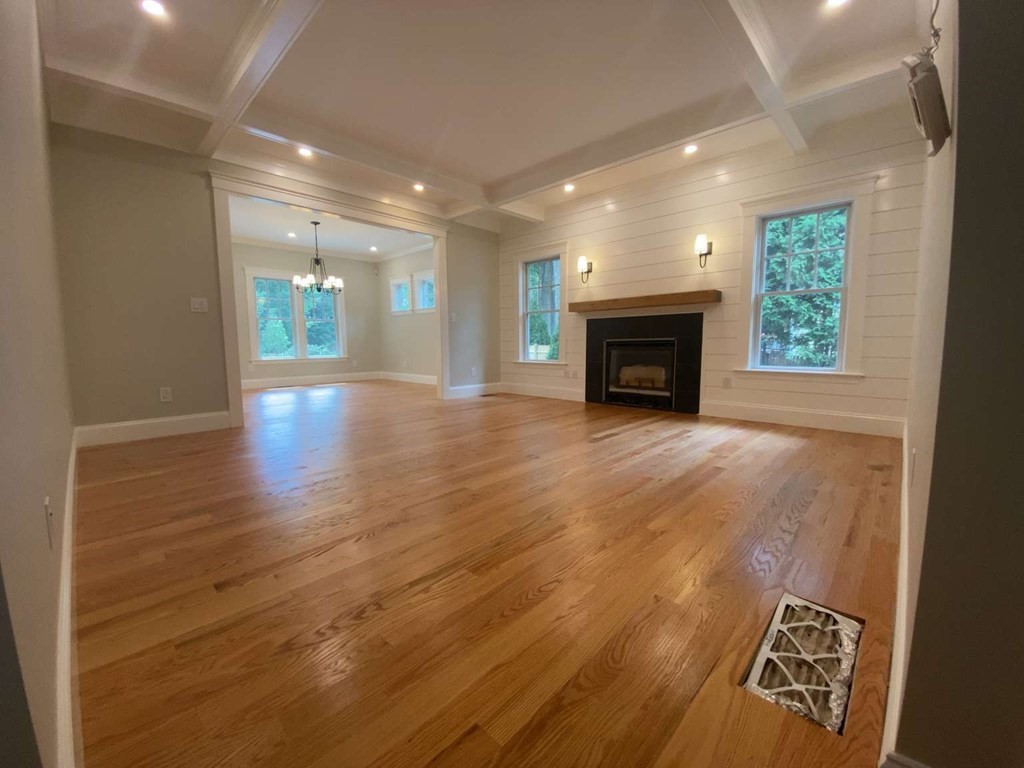 3 Wellesley Avenue, Unit 3 Needham, MA 02494 - Photo 3 of 19 an empty room with wooden floor fireplace and windows