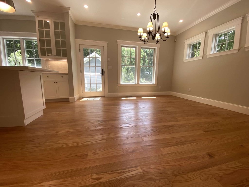 3 Wellesley Avenue, Unit 3 Needham, MA 02494 - Photo 5 of 19 a view of an empty room with wooden floor and a window