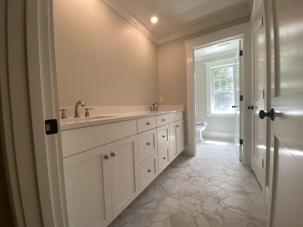3 Wellesley Avenue, Unit 3 Needham, MA 02494 - Photo 10 of 19 a bathroom with a double vanity sink a toilet and a mirror