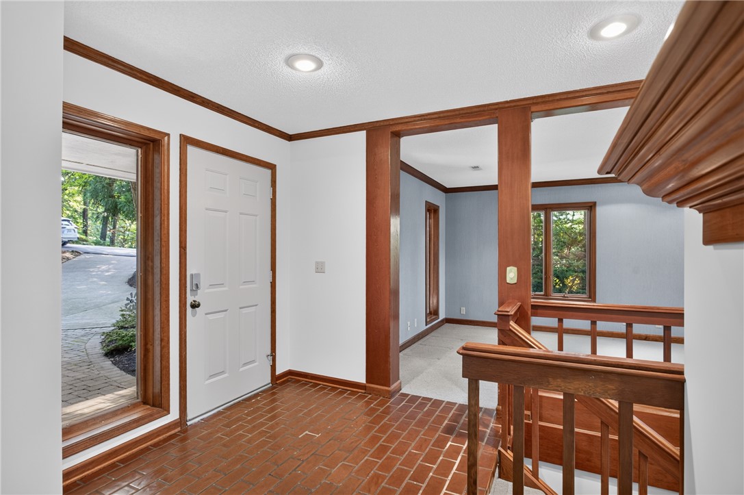 12 Lookout Lane Salem, SC 29676 - Photo 6 of 47 A welcoming entry features terra cotta tile flooring and rich wood accents, leading to sun-filled interior spaces.