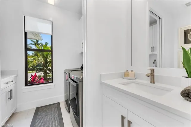 a view of a patio with a table and chairs under an umbrella