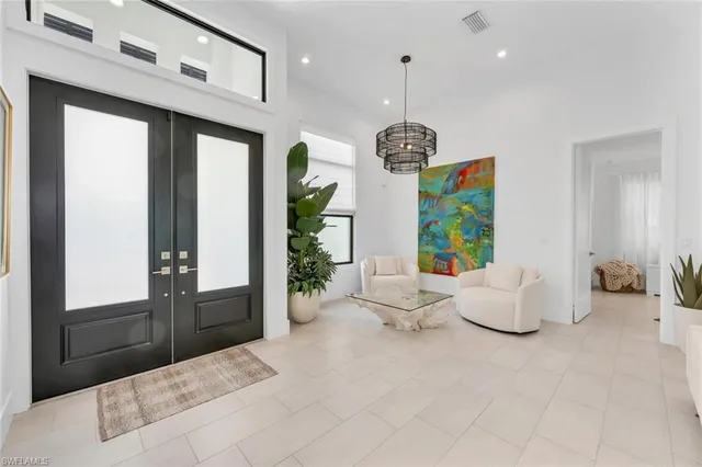 a living room with hard wood flooring and furniture