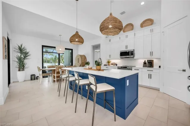 a kitchen with a cabinets a counter space and stainless steel appliances