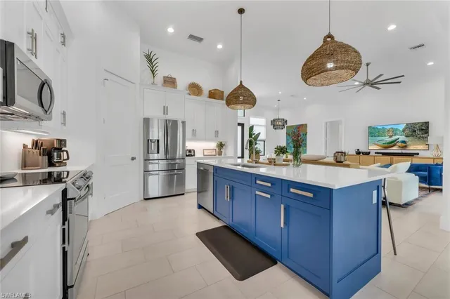 a kitchen with stainless steel appliances a stove center island and a refrigerator