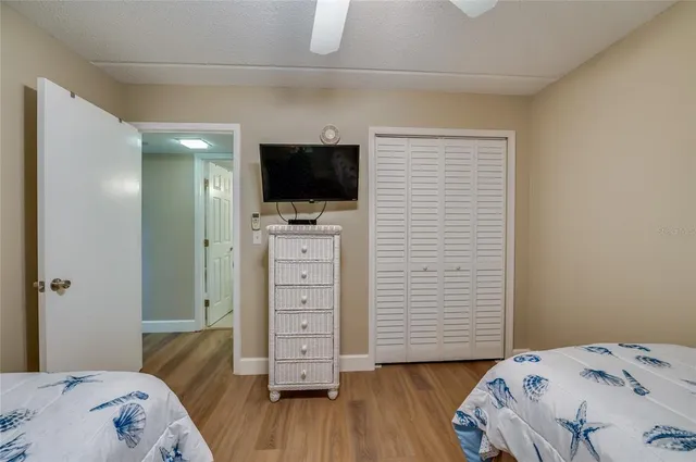 a bathroom with a granite countertop toilet a sink and a large mirror