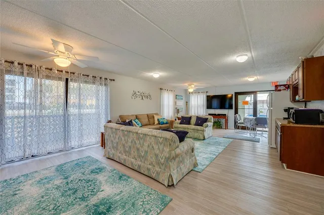 a living room with furniture kitchen area and a couch